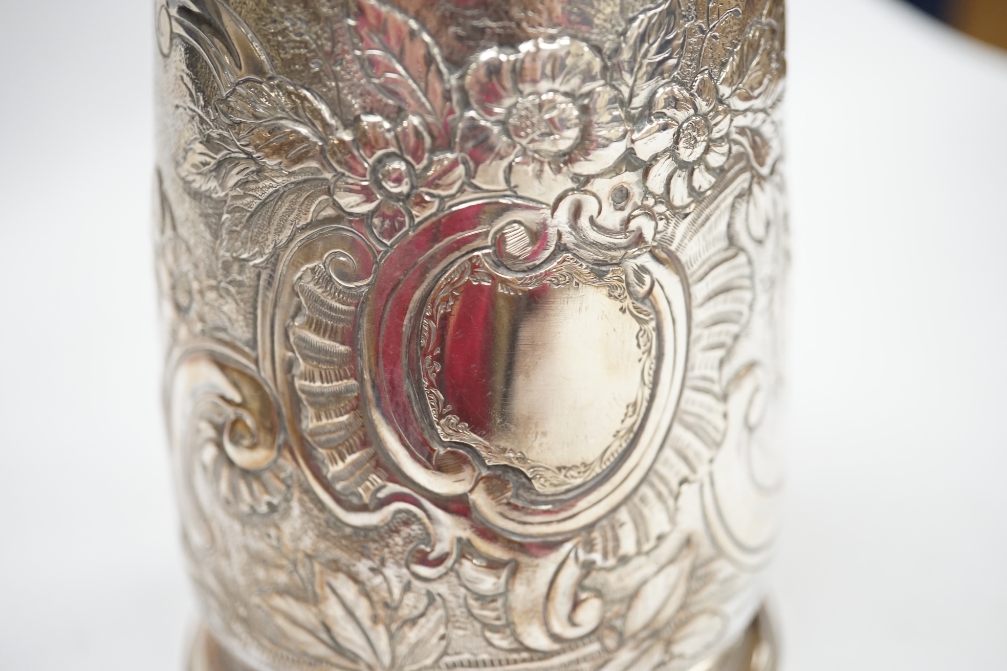 A George II silver mug, with later embossed decoration, Thomas Rush, London, 1733, 11.5cm, 11.9oz. Condition - fair to good